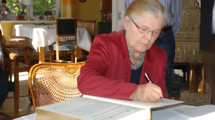 Gisela Freimark trägt sich und auch im Namen ihres Mannes Hans-Peter ins Goldene Buch der Stadt Perleberg ein. 