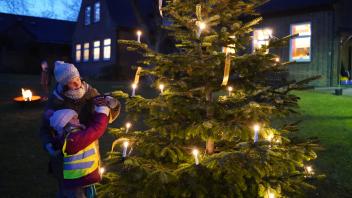 Vorweihnachtliche Aktion in Corona-Zeiten: Jana Rosentreter und ihre Tochter Mirabelle hängen einen Wunsch an den “Weihnachtsbaum der guten Wünsche”