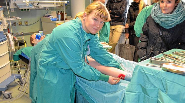 Fast real: Dozentin Cindy Tiede (l.) erklärt Anne Hillig an einer Puppe den Ablauf einer Operation. julb