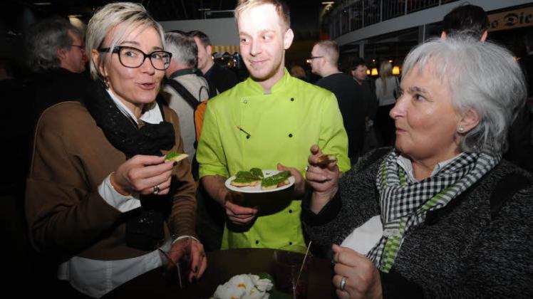 Oliver Bahlmann vom Burghotel Lenzen verteilt Häppchen mit Rucola-Mandel-Pesto. Renate Strehle  (r.) und Melanie Nerlich sind sich einig: „Das schmeckt lecker.“