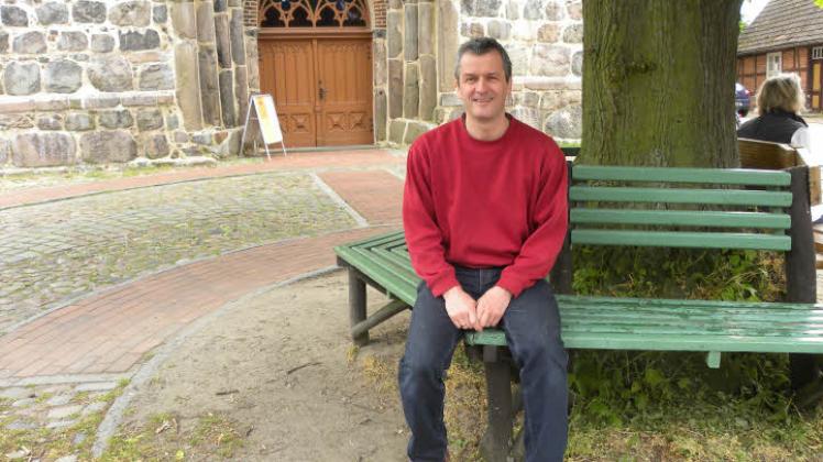 Ein Platz zum Durchatmen: Auf der Bank vor seiner Kirche in Plau am See ist Pastor Stephan Poppe häufiger anzutreffen.  
