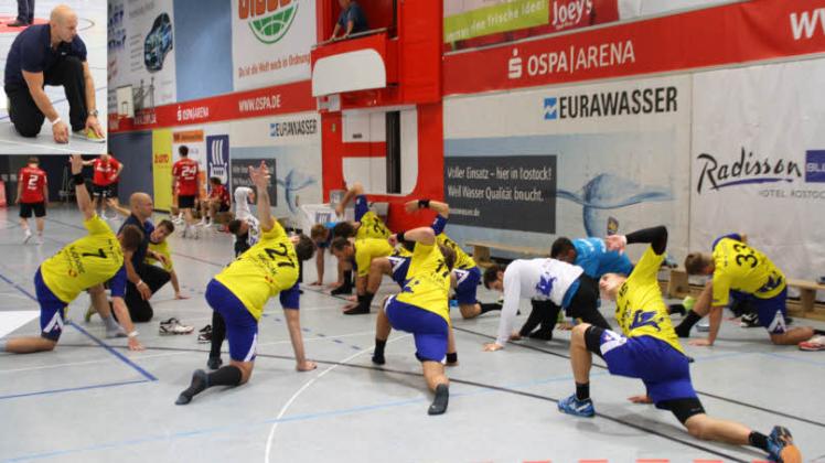 Athletiktrainer Janis Kalnins  führt nach dem Sieg über Essen nach zweimaliger Verlängerung und Siebenmeterwerfen mit den Empor-Handballern Entspannungsübungen durch.  