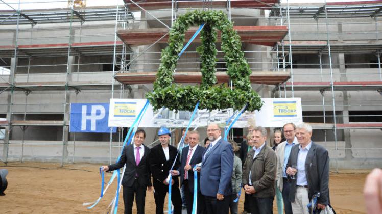 Richtkrone über Offiziellen: Firmenchef  Harry Briese (3.v.l.), Minister Harry Glawe (M.) und der Schweriner Planer Hans Peter Schmidt (4.v.r.) feierten den Hochbau in den Göhrener Tannen. 