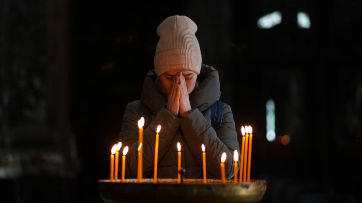 A woman prays in Castrense Saints Peter and Paul Garrison s church, 03 March 2022, in Lviv, Ukraine. This parish is pick