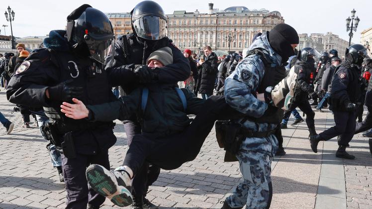 MOSCOW, RUSSIA - MARCH 6, 2022: Law enforcement officers detain a demonstrator during an unsanctioned protest against th
