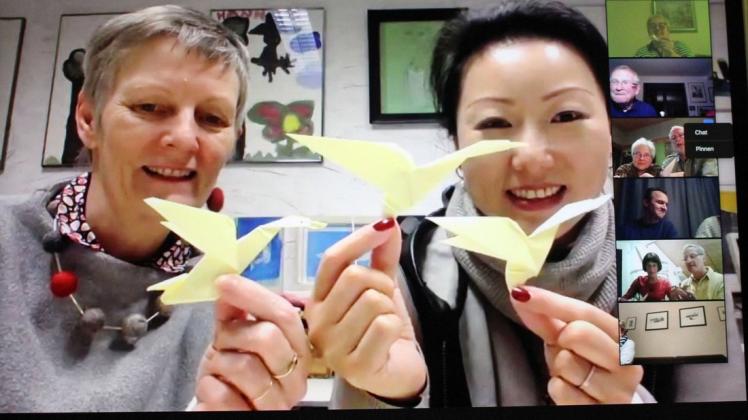 Origami mal online: Die Güstrower Rotarier setzten die Anweisungen von Kunsthaus-Mitarbeiterin Yibo Liu um. Links: Irene Heinze, Vorsitzende des Trägervereins.