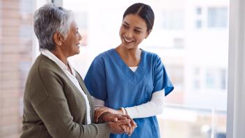Shot of a young nurse caring for a senior woman