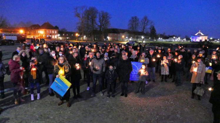 Rund 250 Menschen versammeln sich Mittwochabend vor dem Ludwigsluster Schloss, um gegen den Krieg in der Ukraine zu protestieren.