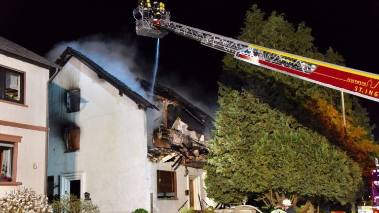 Feuerwehrleute löschen den Brand nach einer Explosion in einem Mehrfamilienhaus.  Foto: dpa/Becker & Bredel
