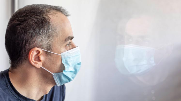 Die Corona-Quarantäne soll verkürzt werden. Welche Änderungen bei den Vorschriften geplant sind. mann,zuhause,mund-nasen-schutz,männer,männlich,häusliches leben,zu hause *** man,home,guy,men,homes sre-g40 ,model relea