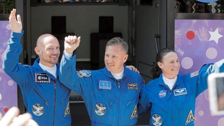 Der deutsche Astronaut Alexander Gerst (l-r), der russische Kosmonaut Sergej Prokopjew und die US-amerikanische Astronautin Serena Aunon-Chancellor winken vor der Abfahrt mit einem Bus vom Hotel zum Kosmodrom. 