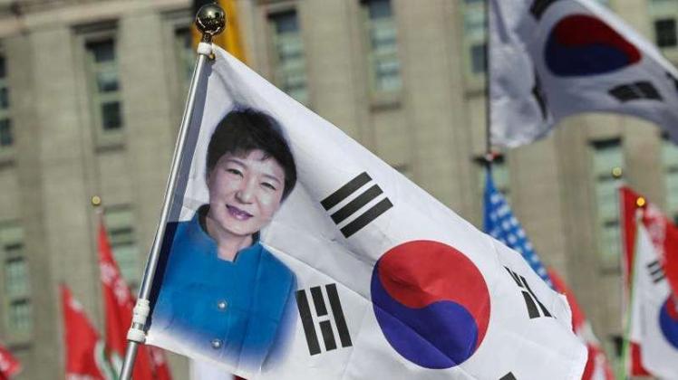 Teilnehmer einer Demonstration halten in Seoul eine Flagge mit einem Porträt von Präsidentin Park Geun Hye. 