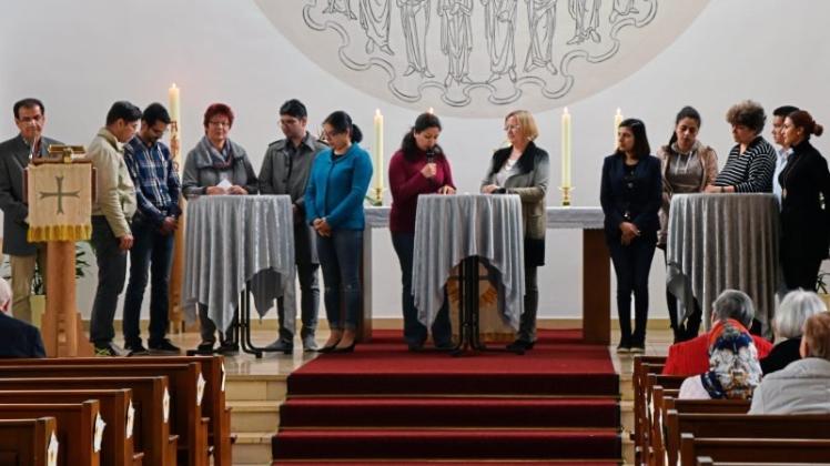 Iris Bretthauer (Vierte von links), Ingeborg Tödter (Sechste von rechts) und Pfarrerin Anne Frerichs (Dritte von rechts) stellten die neugetauften Geflüchteten der Gemeinde vor und befragten sie zu den Beweggründen der Konversion. 