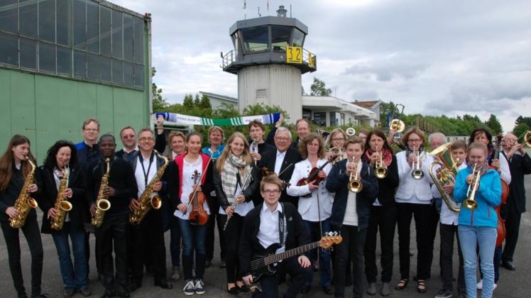 Das Orchester posiert auf dem Flughafen Höxter-Holzminden. 