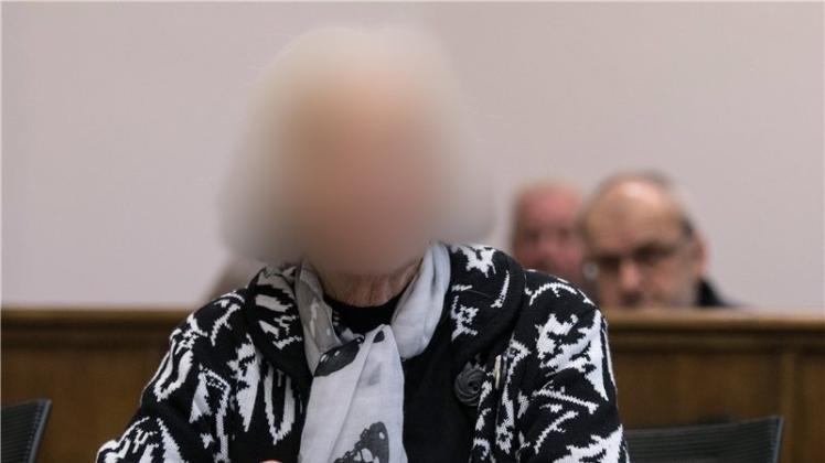 Eine wegen erpresserischen Menschenraubs und besonders schwerer räuberischer Erpressung angeklagte 90-Jährige sitzt vor Auftakt des Prozesses im Verhandlungssaal im Landgericht von Aurich. 