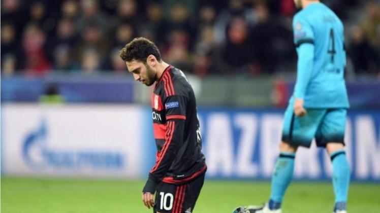 Nach dem knappen Aus in der Champions League kniet Leverkusens Hakan Calhanoglu auf dem Spielfeld. 