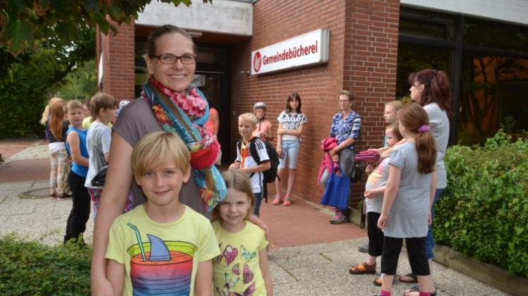 Schlange stehen für den Ferienspaß: Daniela Beecken und ihre Kinder Lukas und Liene warteten mit vielen weiteren jungen Ganderkeseern auf die Büchereiöffnung. 
