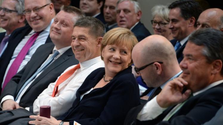 Bundeskanzlerin Angela Merkel (CDU, M) sitzt neben ihrem Ehemann Joachim Sauer am 17.Juli b2014 n während eines Empfangs zu ihrem 60. Geburtstag. Foto:dpa
