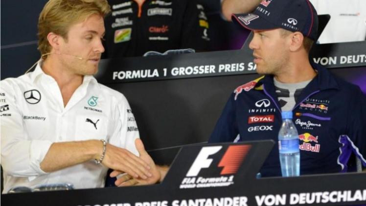 Nico Rosberg (l) und Sebastian Vettel erhoffen sich durch den WM-Titel der Fußballer einen Schub beim Heimrennen. 
