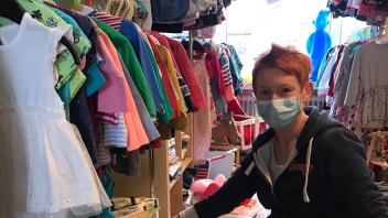 Melanie Hilmes hängt neue Ware ins Regal ihrer Babybörse in Wellendorf