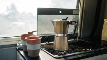 Coffee warming up in the kitchen of a motorhome next to two cups JakeJakab_LikeFatherLikeSon_5.jpg Copyright: xJakexJaka