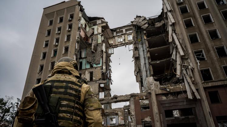 April 14, 2022, Mykolaiv, Mykolaiv s Oblast, Ukraine: A soldier stands in front the destroyed part of the Ukrainian gove