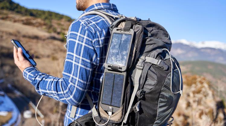 Man wearing backpack with portable solar panel on sunny day model released, VEGF05332
