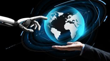 human and robot hand with virtual earth hologram