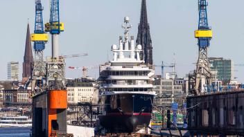 Yacht "Luna" is seen lying in dry dock at the German shipbuilding company Blohm + Voss compound on the river Elbe at the harbour in Hamburg, northern Germany, on March 7, 2022. - Luna is the world’s second-largest expedition yacht and featured at the centre of a dispute between Azerbaijani business man Farkhad Akhmedov and his ex-wife, Tatyana Akhmedova. Luna now belongs to the Blue Sea Trust, reported to be the owning entity of the Akhmedov family. (Photo by Odd ANDERSEN / AFP)