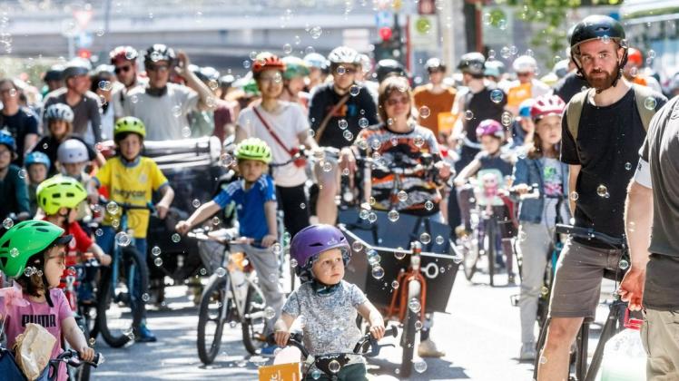 Eltern demonstrieren mit ihren Kindern auf einer "Kidical Mass" Fahrrademo für sichere Schulradwege für Hamburgs Kinder.