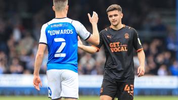 Sky Bet Championship Peterborough v Blackpool Jake Daniels 43 of Blackpool shakes pads with Ronnie Edwards 2 of Peterbor