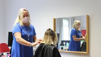 Hausbesuch in der Gemeinschaftsunterkunft: Friseurin Andrea Krewel schneidet einer Bewohnerin die Haare, knapp 21 von ihnen hatten das Angebot am ersten Tag wahrgenommen.