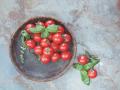 Tomatoes in a wooden bowl on rustic table. Overhead view with retro style processing. Natural light , 20105580.jpg, bowl