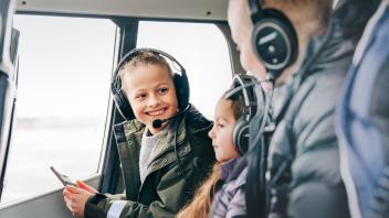 Smiling young boy with family on a helicopter ride