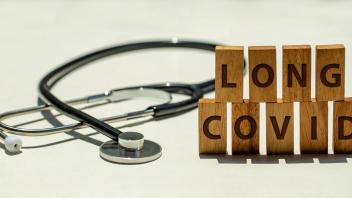 Stethoscope and wooden blocks with wording "LONG COVID"