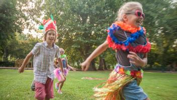 Cheerful children in costume running at park model released Symbolfoto AJOF00590