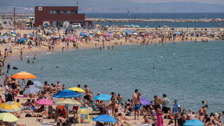 May 22, 2022, Barcelona, Spain: A multitude of bathers are seen looking for refreshments at La Nova IcÃ ria Beach. Barc