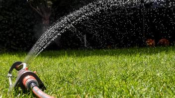 Illustration picture shows a sprinkler connected to a water hose, for watering the grass, in a garden in Edegem, Tuesday
