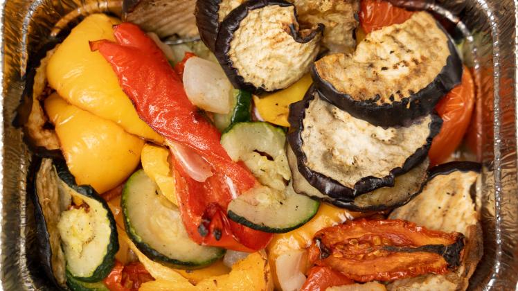 10 February 2022: Grilled colorful vegetables, grilled vegetables in an aluminum bowl, eggplant, zucchini, peppers mixtu
