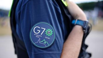 Das G7-Logo ist auf dem Ärmel eines Polizisten zu sehen. Foto: Philipp von Ditfurth/dpa