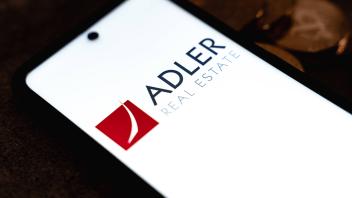 Germany - 08 October 2021: Adler Real Estate logo on a smartphone display, stock market crash scam on the stock market