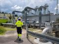 An employee of Uniper Energy Storage walks through the above-ground facilities of a natural gas storage facility  at the Uniper Energy Storage facility in Bierwang, southern Germany on June 10, 2022. (Photo by LENNART PREISS / AFP)