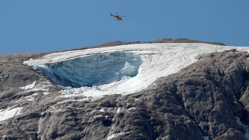 July 4, 2022, CANAZEI, Italy: A helicopter flies over the avalanche area to search for people still missing on the Marm