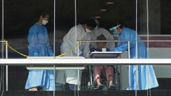 Daily Life In Singapore Amid The COVID-19 Pandemic Healthcare workers dressed in personal protective equipment (PPE) att