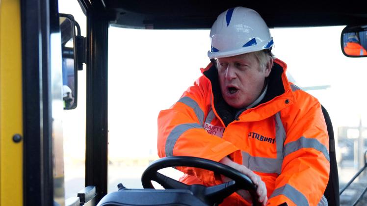 (FILES) In this file photo taken on January 31, 2022 British Prime Minister Boris Johnson drives a forklift as he visits the Tilbury Docks in Tilbury. - Boris Johnson rode his luck throughout his career, bouncing back from a succession of setbacks and scandals that would have sunk other less popular politicians. But the luck of a man once likened to a "greased piglet" for his ability to escape controversies finally ran out, after a slew of high-profile resignations from his scandal-hit government. (Photo by Matt Dunham / POOL / AFP)