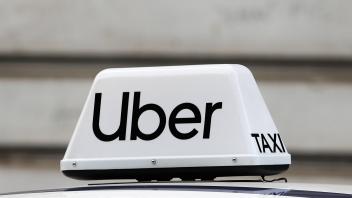 Economy And Daily Life In Krakow Uber taxi sign is seen on a car in Krakow, Poland, on May 30, 2022. Krakow Poland PUBLI