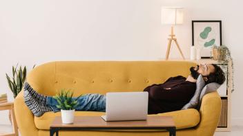Man with eyes closed relaxing on sofa in living room at home model released, Symbolfoto property released, XLGF02920