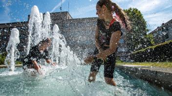 People refresh themself in the public fountain in Hradec Kralove, Czech Republic, on Wednesday, July 20, 2022. (CTKxPhot