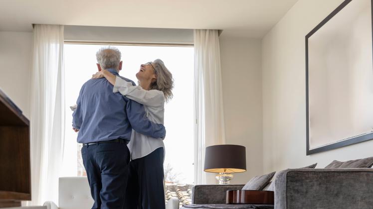Happy senior couple dancing in living room at home model released, Symbolfoto property released, EIF03717