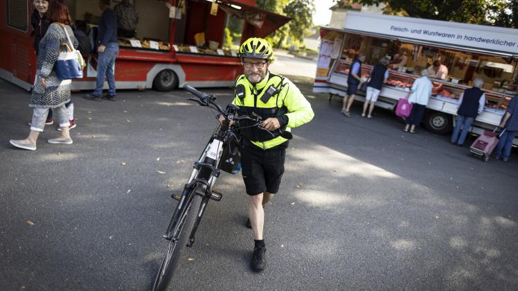 Stadtteil-Cop Uwe-Kersten Uecker patrouilliert am 27.07.2022 mit seinem E-Bike auf dem Wochenmarkt in Osnabrück-Schinkel. Foto: David Ebener ***Stichworte*** Kontaktbereichsbeamte, Kontaktbereichsbeamter, Polizei, Polizist, Pedelec, dam-archiv